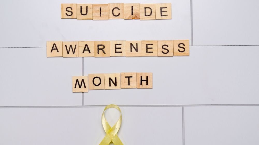 A caring person offering supportive help by recognising suicide warning signs